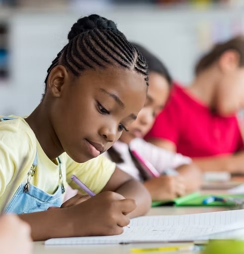 A child learning happily with a Budding Gems educator